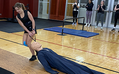 Woman dragging a dummy